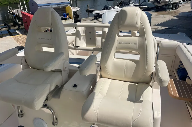 Slide: The Image of 2018 Grady-White Canyon 306 boat seats, featuring luxurious white leather upholstery. - 18