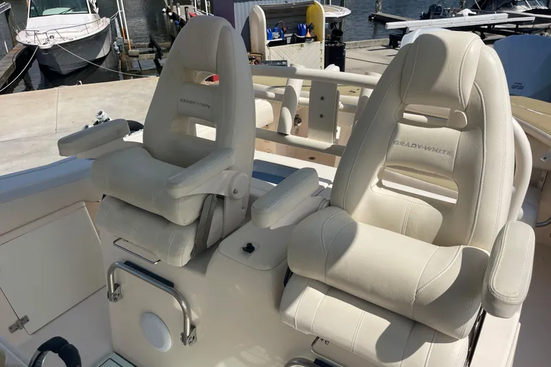 Slide: The Image of 2018 Grady-White Canyon 306 boat seats at marina, showcasing luxury and comfort. - 19