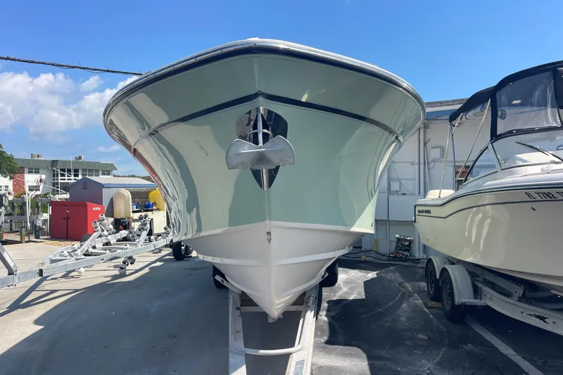 Slide: The Image of 2018 Grady-White Canyon 306 boat on trailer, parked outdoors under clear sky. - 2