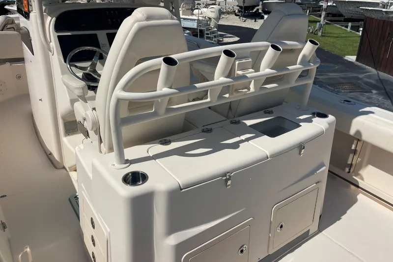 Slide: The Image of 2018 Grady-White Canyon 306 boat interior with rod holders and helm station. - 20