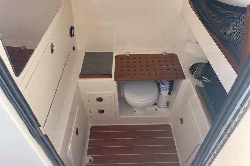 Slide: The Image of 2018 Grady-White Canyon 306 boat interior with compact bathroom amenities. - 21