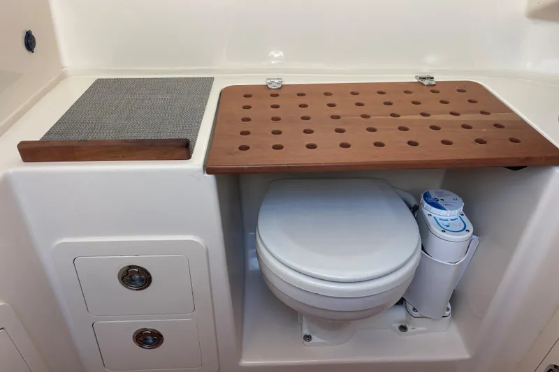 Slide: The Image of 2018 Grady-White Canyon 306 boat interior with toilet and storage compartments. - 22