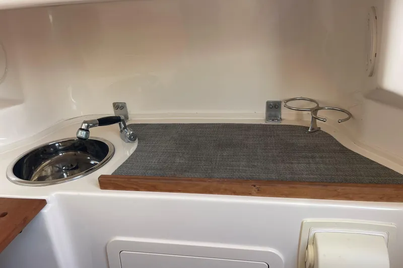 Slide: The Image of 2018 Grady-White Canyon 306 boat interior with sink and cup holders. - 23
