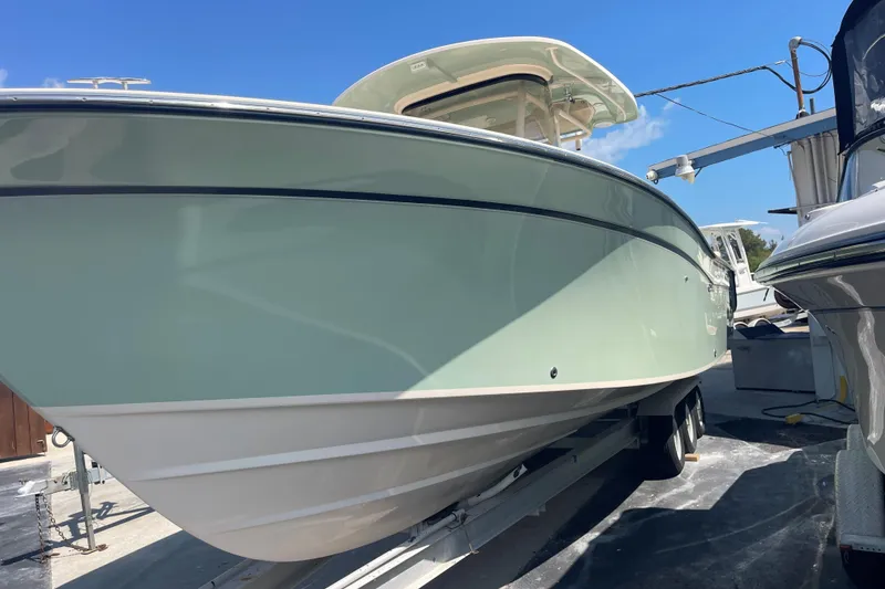 Slide: The Image of 2018 Grady-White Canyon 306 boat on trailer under clear blue sky. - 3