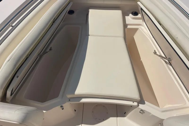 Slide: The Image of 2018 Grady-White Canyon 306 boat interior with cushioned seating and storage compartments. - 8