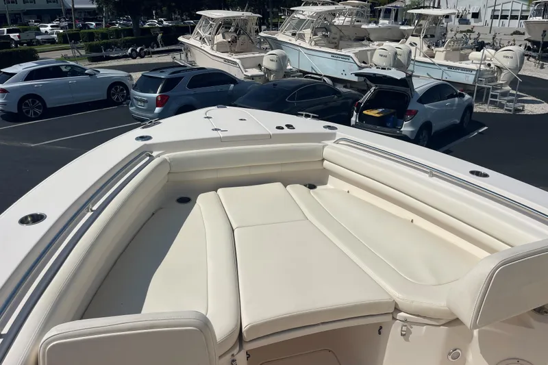 Slide: The Image of 2018 Grady-White Canyon 306 boat with spacious seating, parked in a marina. - 9