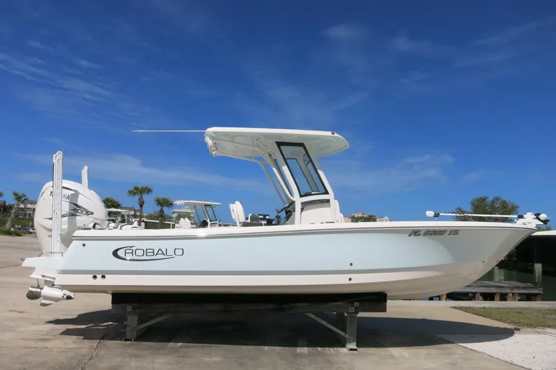 The Image of 2022 Robalo 266 Cayman boat on display under clear blue sky. - 0