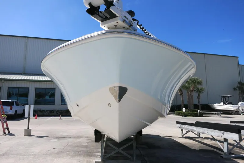 Slide: The Image of 2022 Robalo 266 Cayman boat on display at a marina under clear blue skies. - 11