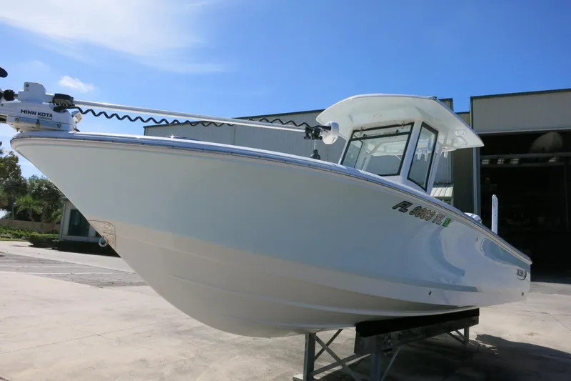 Slide: The Image of 2022 Robalo 266 Cayman boat on display, featuring sleek design and Minn Kota trolling motor. - 12
