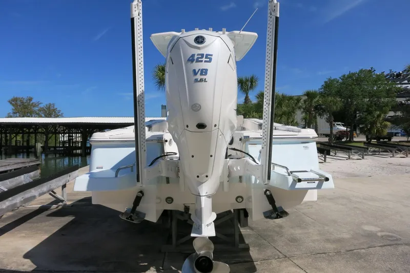Slide: The Image of 2022 Robalo 266 Cayman boat with powerful 425 HP outboard engine, docked outdoors. - 16