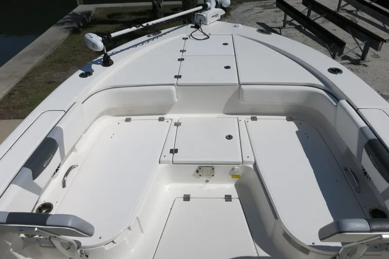 Slide: The Image of 2022 Robalo 266 Cayman boat interior with spacious seating and storage compartments. - 24
