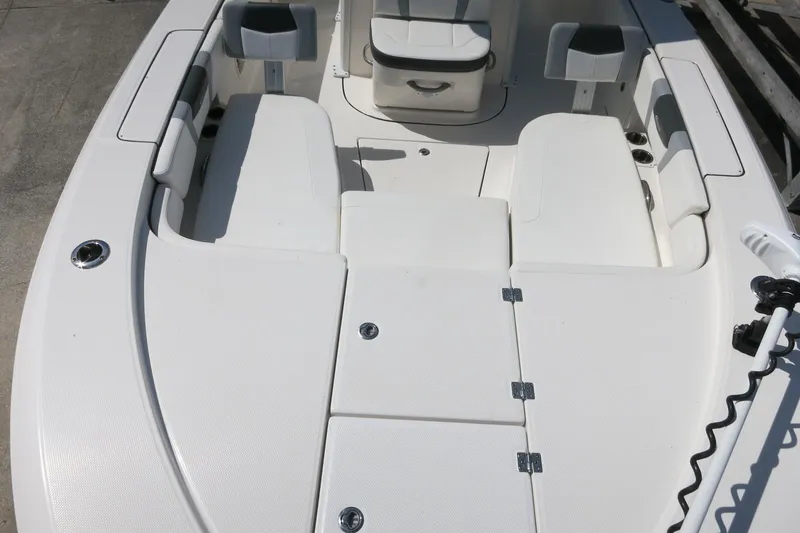 Slide: The Image of 2022 Robalo 266 Cayman boat interior with white seating and storage compartments. - 27
