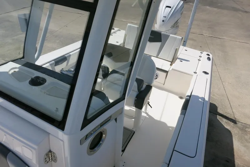 Slide: The Image of 2022 Robalo 266 Cayman boat interior with seating and console, viewed from above. - 29