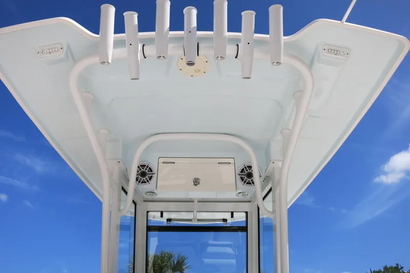 Slide: The Image of T-top view of 2022 Robalo 266 Cayman boat against clear blue sky. - 31