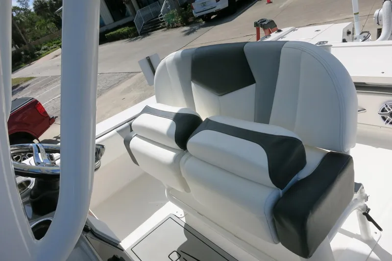 Slide: The Image of 2022 Robalo 266 Cayman boat interior with dual-tone cushioned seating. - 33