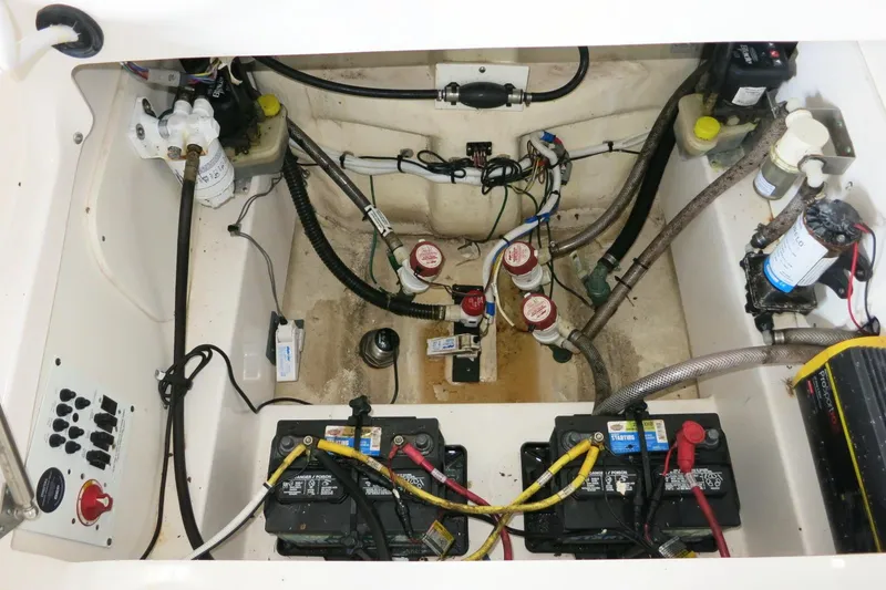 Slide: The Image of Engine compartment of a 2022 Robalo 266 Cayman boat, showing batteries and wiring. - 41