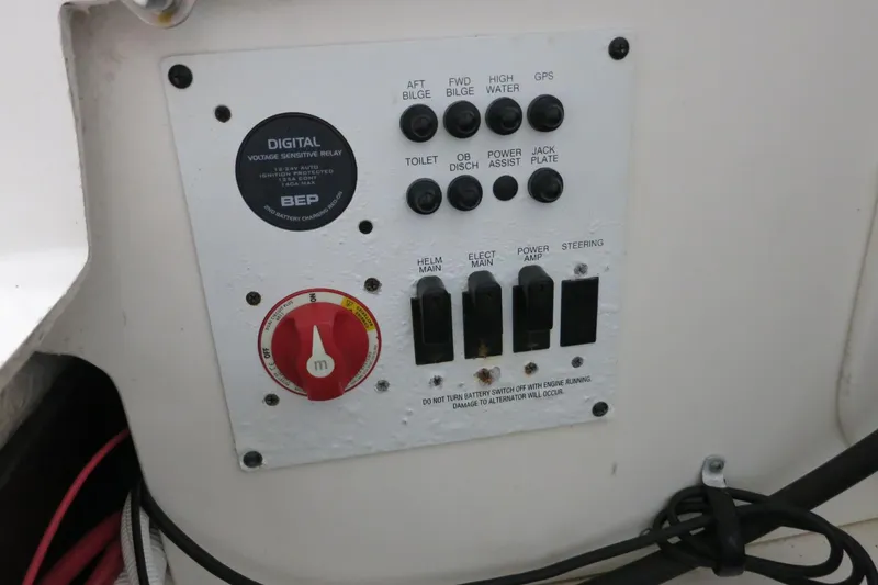 Slide: The Image of Control panel on a 2022 Robalo 266 Cayman boat with switches and dials. - 42