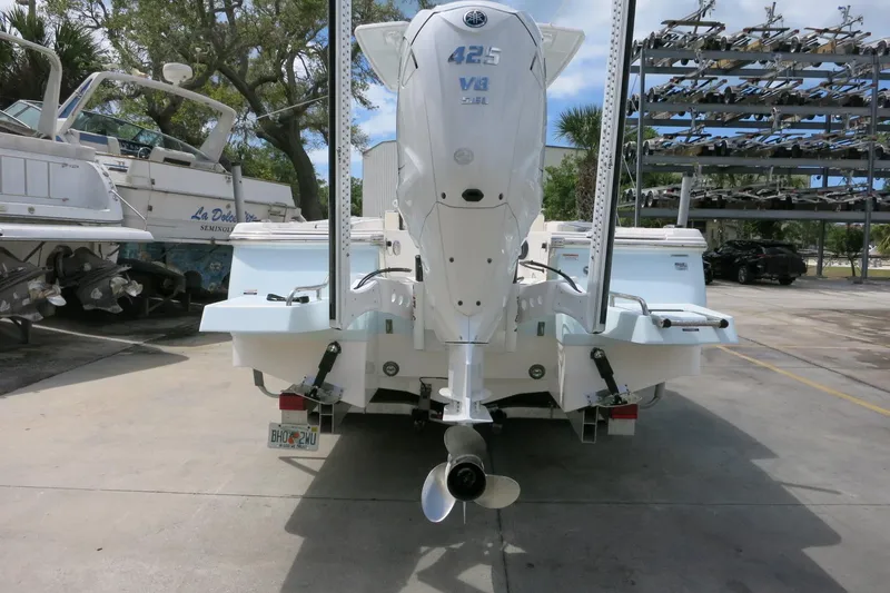 Slide: The Image of 2022 Robalo 266 Cayman boat with Yamaha 425 V8 engine, parked in marina. - 6