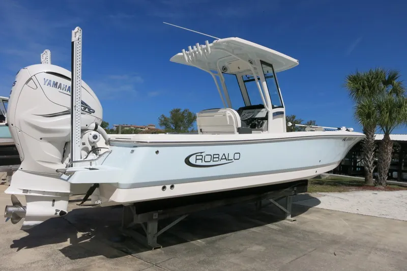 Slide: The Image of 2022 Robalo 266 Cayman boat with Yamaha engine, displayed outdoors on a sunny day. - 7