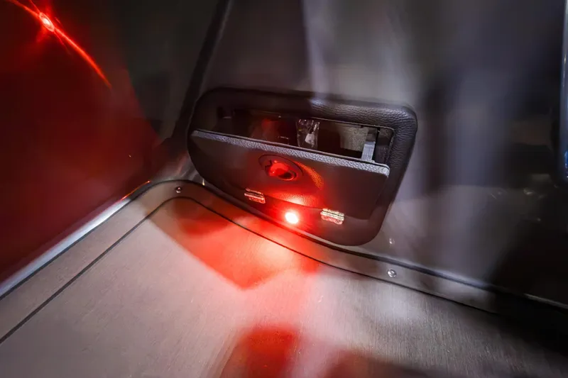 Slide: The Image of Interior detail of 2026 Godfrey Monaco 235 boat with red ambient lighting. - 12