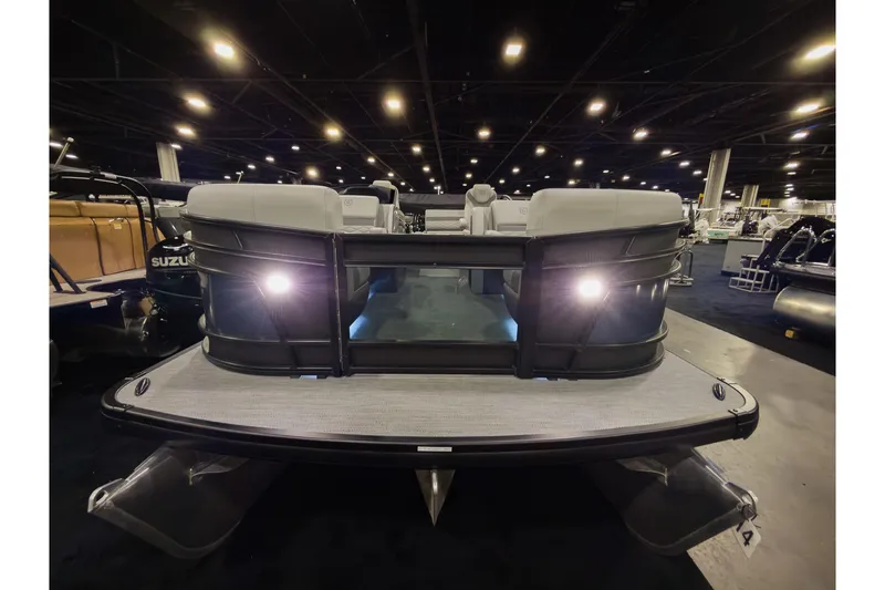 Slide: The Image of 2026 Godfrey Monaco 235 pontoon boat with lights on display indoors. - 3