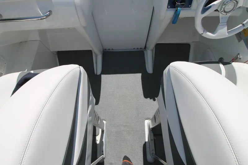 Slide: The Image of Interior of a 2006 Formula 292 FASTech boat, featuring white seating and steering wheel. - 14