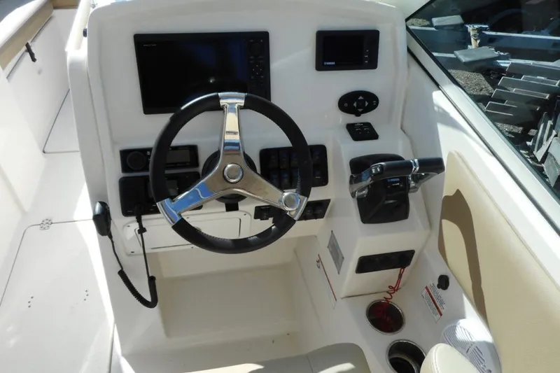 Slide: The Image of Helm of 2020 Sailfish 275 DC boat with steering wheel and control panel. - 10