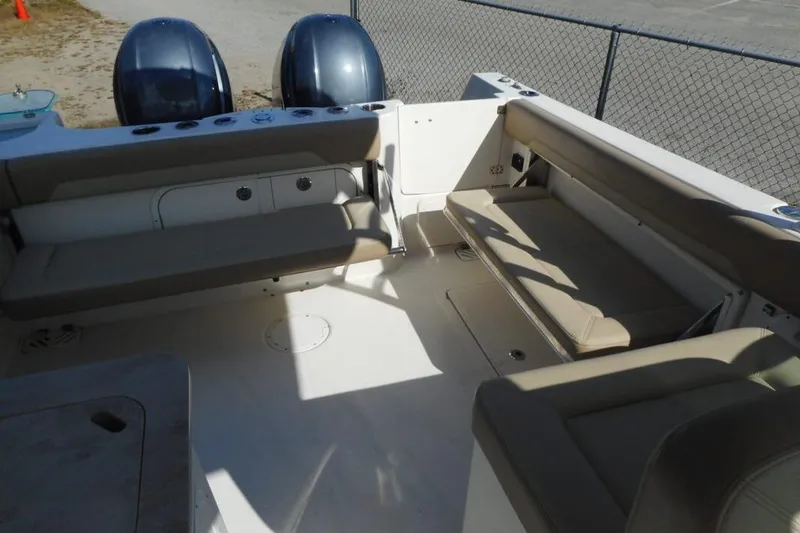 Slide: The Image of 2020 Sailfish 275 DC boat interior with seating and dual outboard motors. - 5