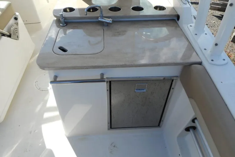 Slide: The Image of 2020 Sailfish 275 DC boat kitchenette with sink and storage. - 6