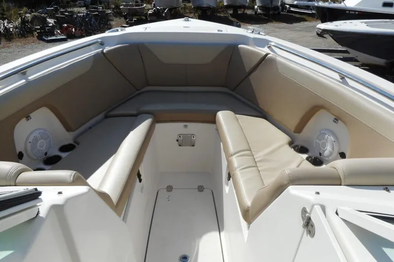 Slide: The Image of Interior view of a 2020 Sailfish 275 DC boat with beige seating and cup holders. - 7