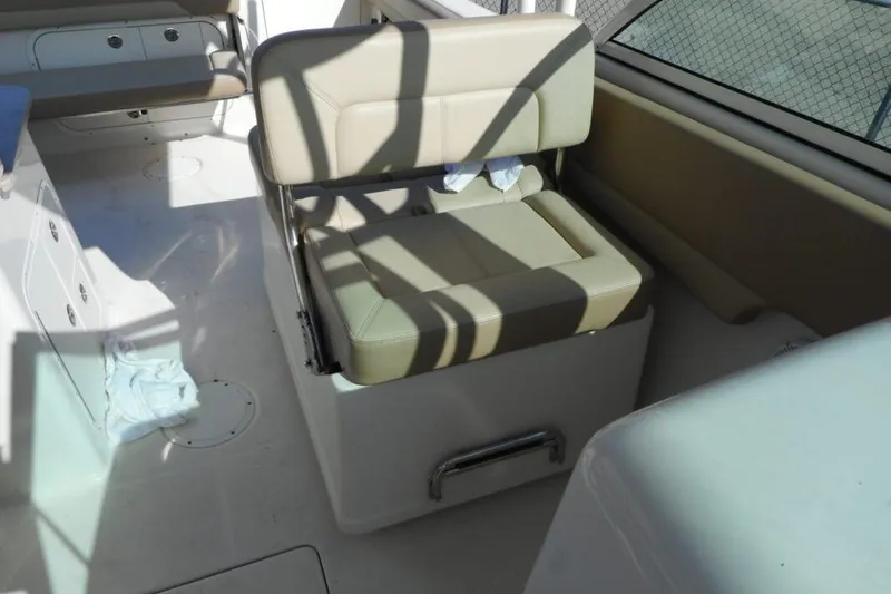 Slide: The Image of Interior seating of 2020 Sailfish 275 DC boat with beige cushions and storage. - 8