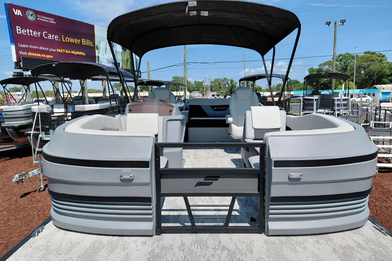 Slide: The Image of 2026 Starcraft VX 24 Q DH pontoon boat displayed outdoors with canopy and seating. - 11