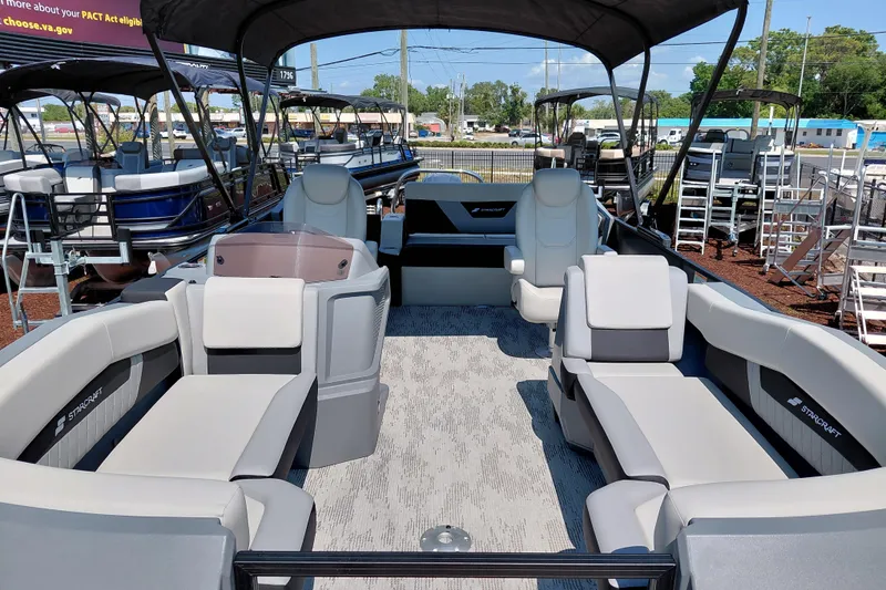 Slide: The Image of 2026 Starcraft VX 24 Q DH pontoon boat interior with plush seating and modern design. - 12