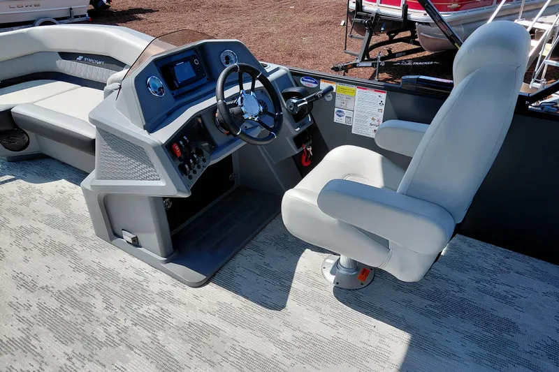 Slide: The Image of Captain's seat and helm of 2026 Starcraft VX 24 Q DH boat, featuring modern controls. - 18