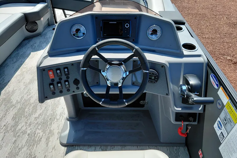Slide: The Image of Steering console of 2026 Starcraft VX 24 Q DH boat with modern controls and gauges. - 19