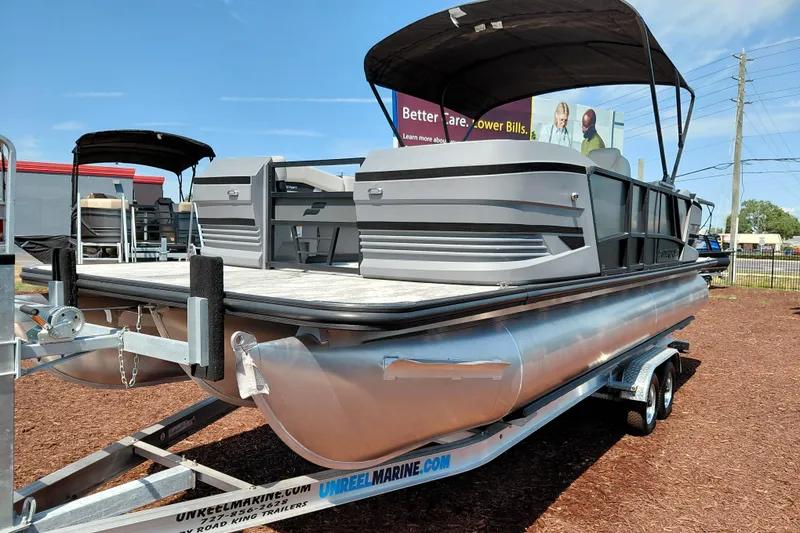 Slide: The Image of 2026 Starcraft VX 24 Q DH pontoon boat on trailer, outdoor display. - 2