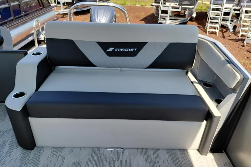 Slide: The Image of Starcraft VX 24 Q DH 2026 boat seating with cup holders, outdoor display. - 22