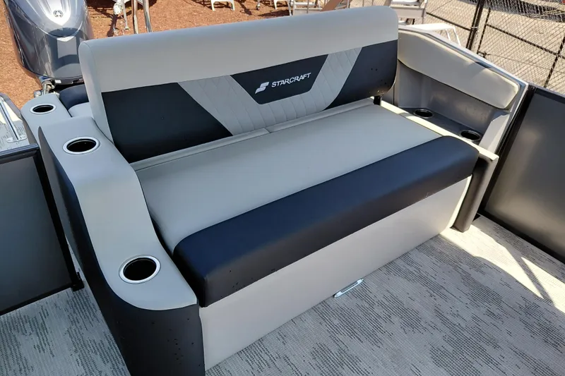 Slide: The Image of Starcraft VX 24 Q DH 2026 boat seating with cup holders, gray and black upholstery. - 23