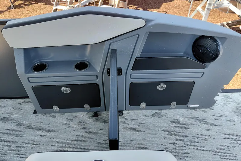 Slide: The Image of Control panel of 2026 Starcraft VX 24 Q DH boat with cup holders and speaker. - 24