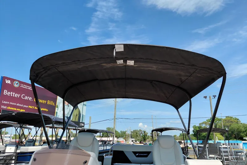 Slide: The Image of 2026 Starcraft VX 24 Q DH boat with canopy under clear blue sky. - 37