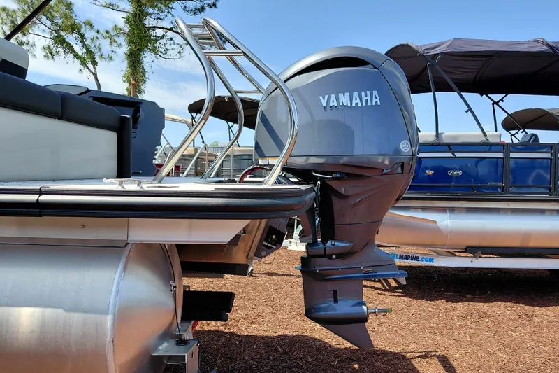 Slide: The Image of 2026 Starcraft VX 24 Q DH pontoon boat with Yamaha outboard motor, docked outdoors. - 5