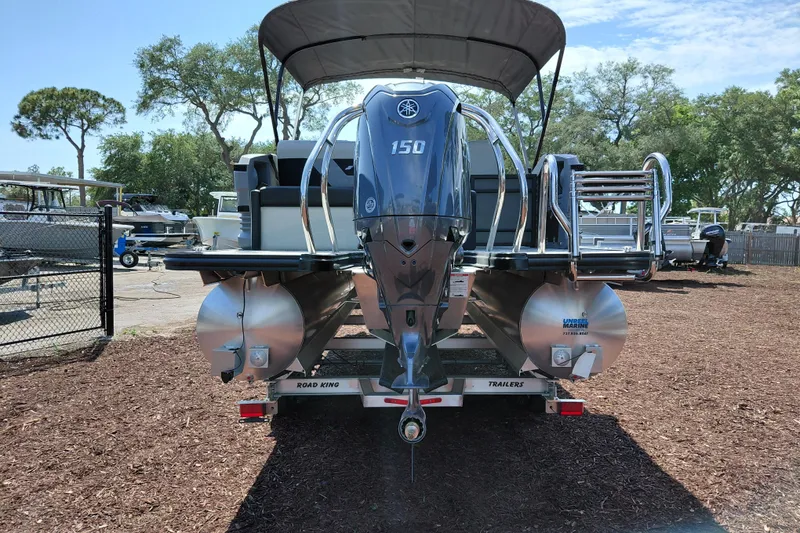 Slide: The Image of 2026 Starcraft VX 24 Q DH pontoon boat with Yamaha 150 engine, parked on trailer. - 6