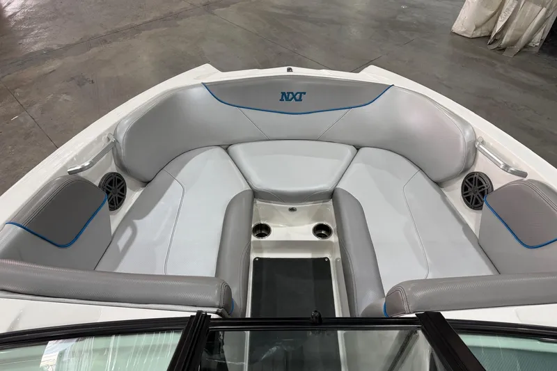Slide: The Image of 2017 MasterCraft NXT22 boat interior with gray seating and blue accents. - 10