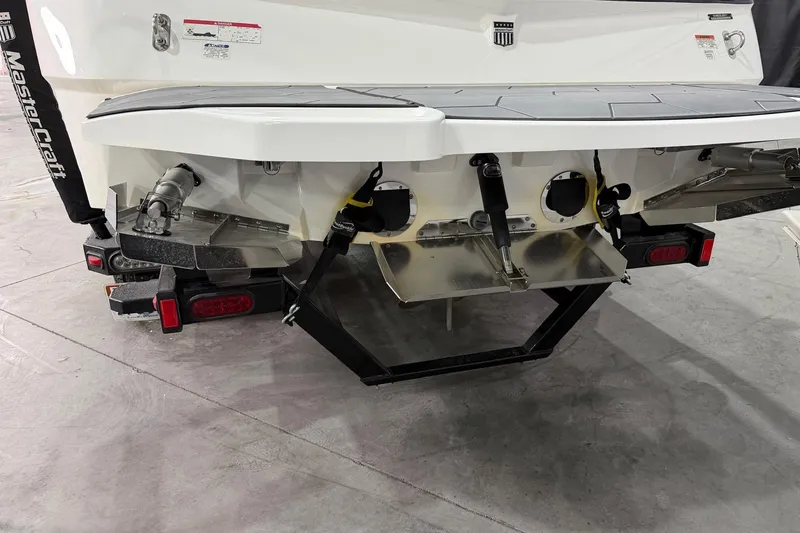 Slide: The Image of Rear view of a 2017 MasterCraft NXT22 boat on a trailer in a garage. - 14