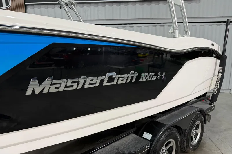 Slide: The Image of 2017 MasterCraft NXT22 boat side view in a garage setting. - 3