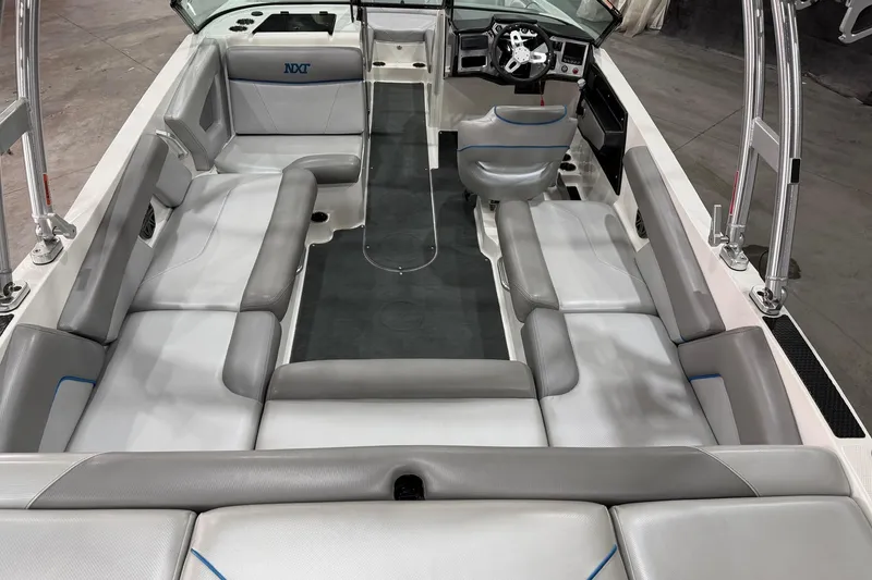 Slide: The Image of 2017 MasterCraft NXT22 boat interior with gray seating and modern dashboard. - 6