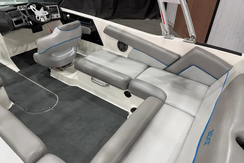 Slide: The Image of 2017 MasterCraft NXT22 boat interior with gray seating and modern dashboard. - 8