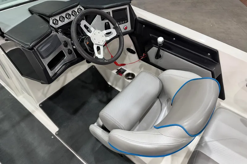 Slide: The Image of 2017 MasterCraft NXT22 boat interior with steering wheel and captain's seat. - 9