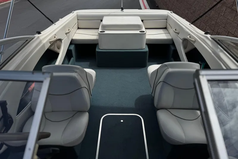 Slide: The Image of Interior of a 2000 Bayliner 2150 Capri boat with seating and carpeted floor. - 11