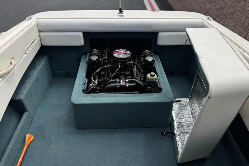 Slide: The Image of 2000 Bayliner 2150 Capri boat engine compartment with visible motor and interior details. - 13